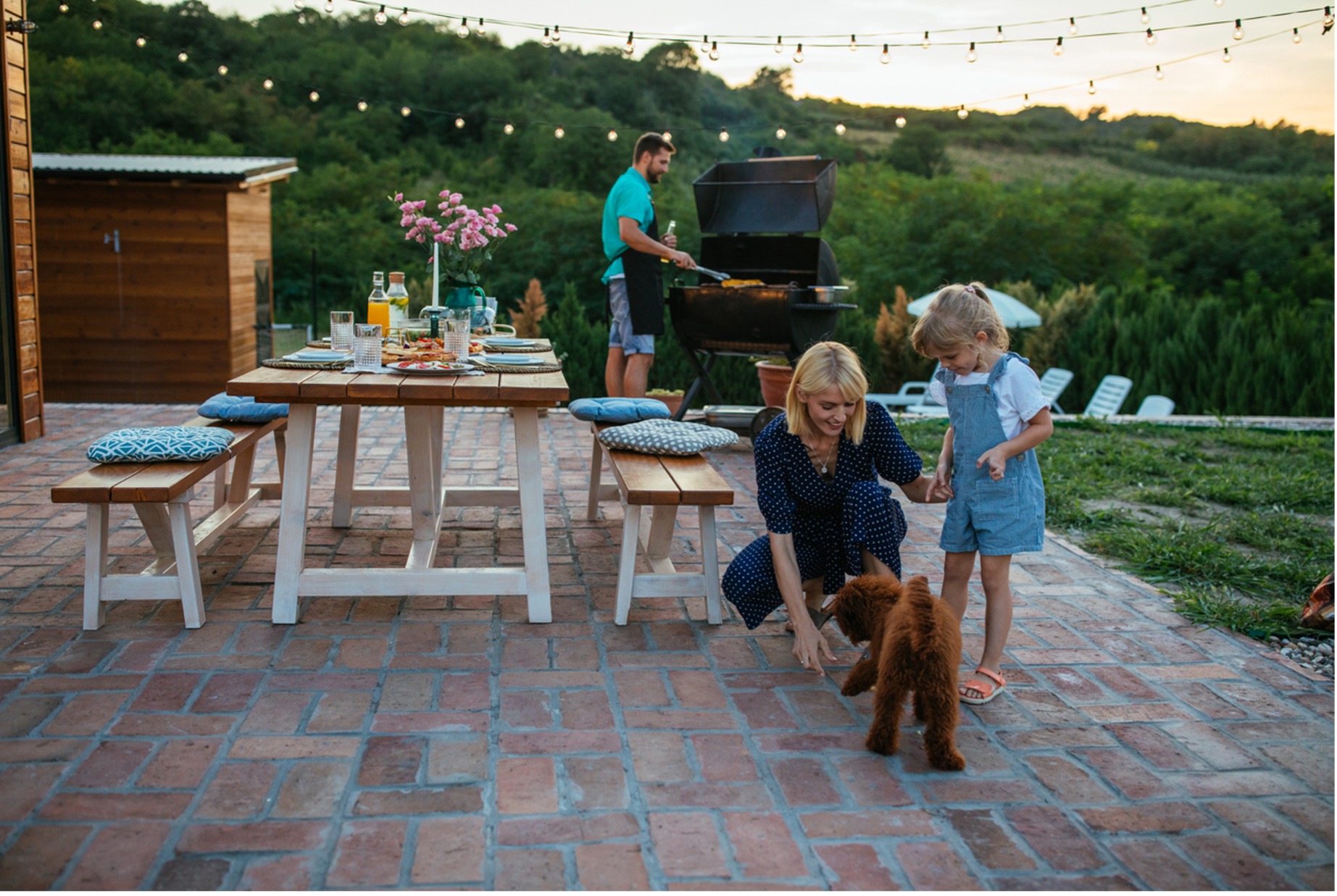 A person and two children playing with a dog outside, Keep Your Pets Safe During Summer Celebrations